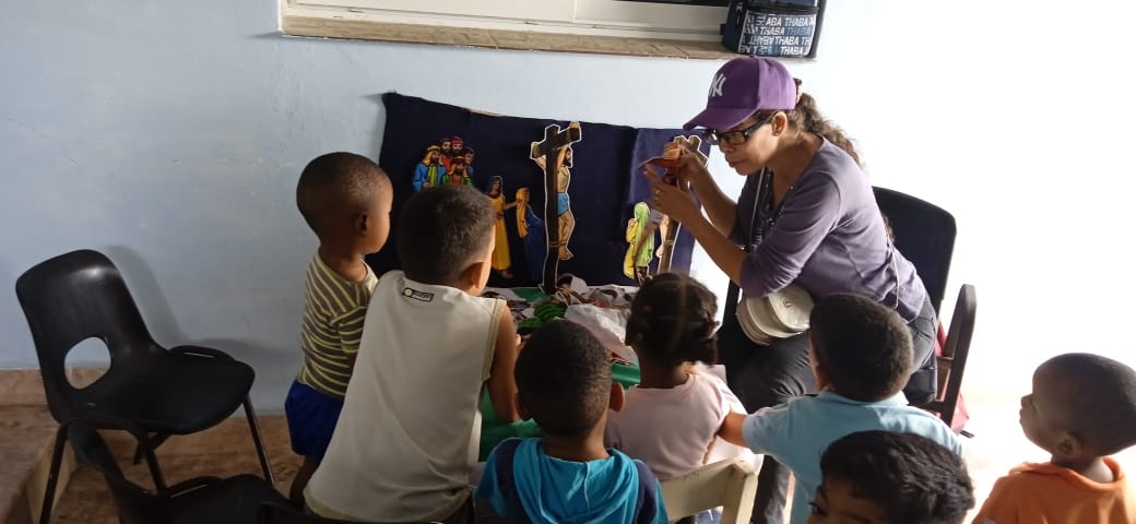 Adult teaching sitting children